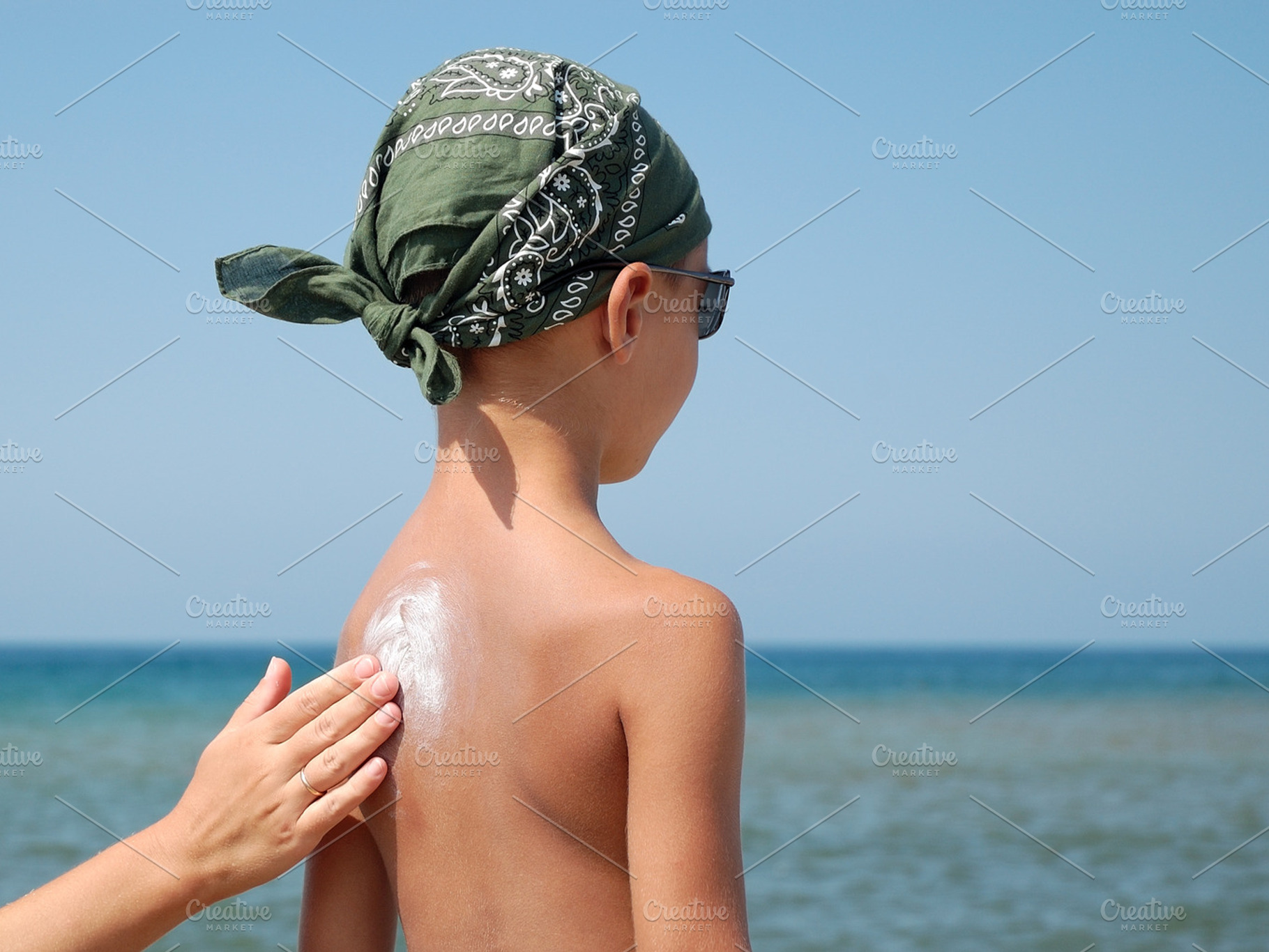 At little child is applied sunscreen