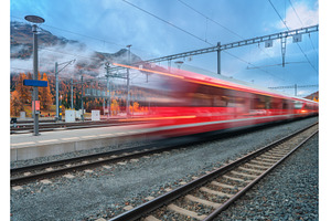 Blurred red passenger train passing, a Transportation Photo by den-belitsky