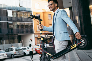 Modern man with electric scooter featuring scooter, electric, and man