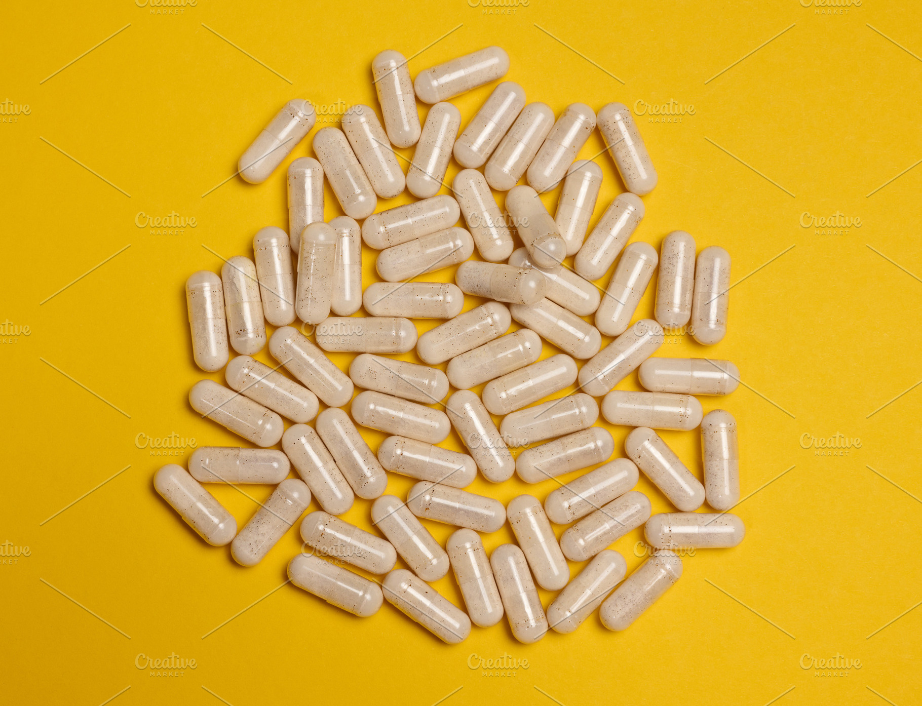 Pills in a capsule on a yellow background, pain treatment., a Health & Medical Photo by ndanko