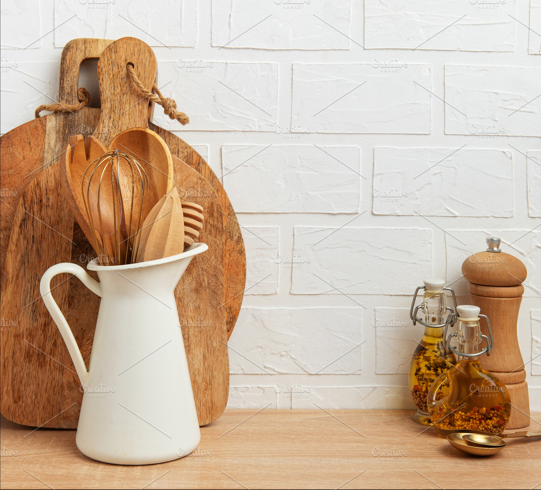 Kitchen utensils resting on wooden countertop by white brick wal, a Food & Drink Photo by Olena Rudo