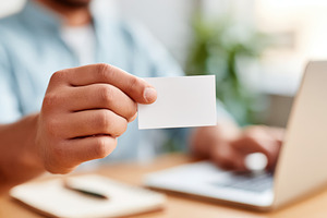Holding a blank business card in an office setting, a Business Photo by AlyaAnd