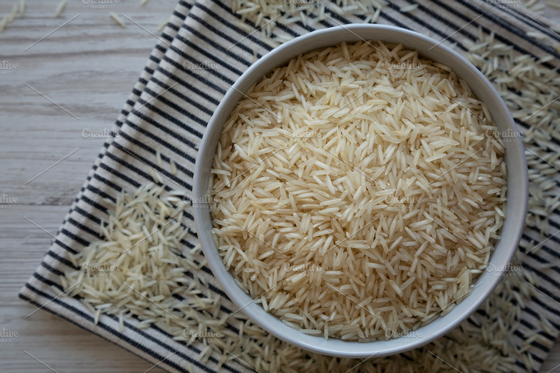 Uncooked White Organic Basmati Rice in a Bowl, top view. Close-u, a Food & Drink Photo by LiudmylaChuhunova