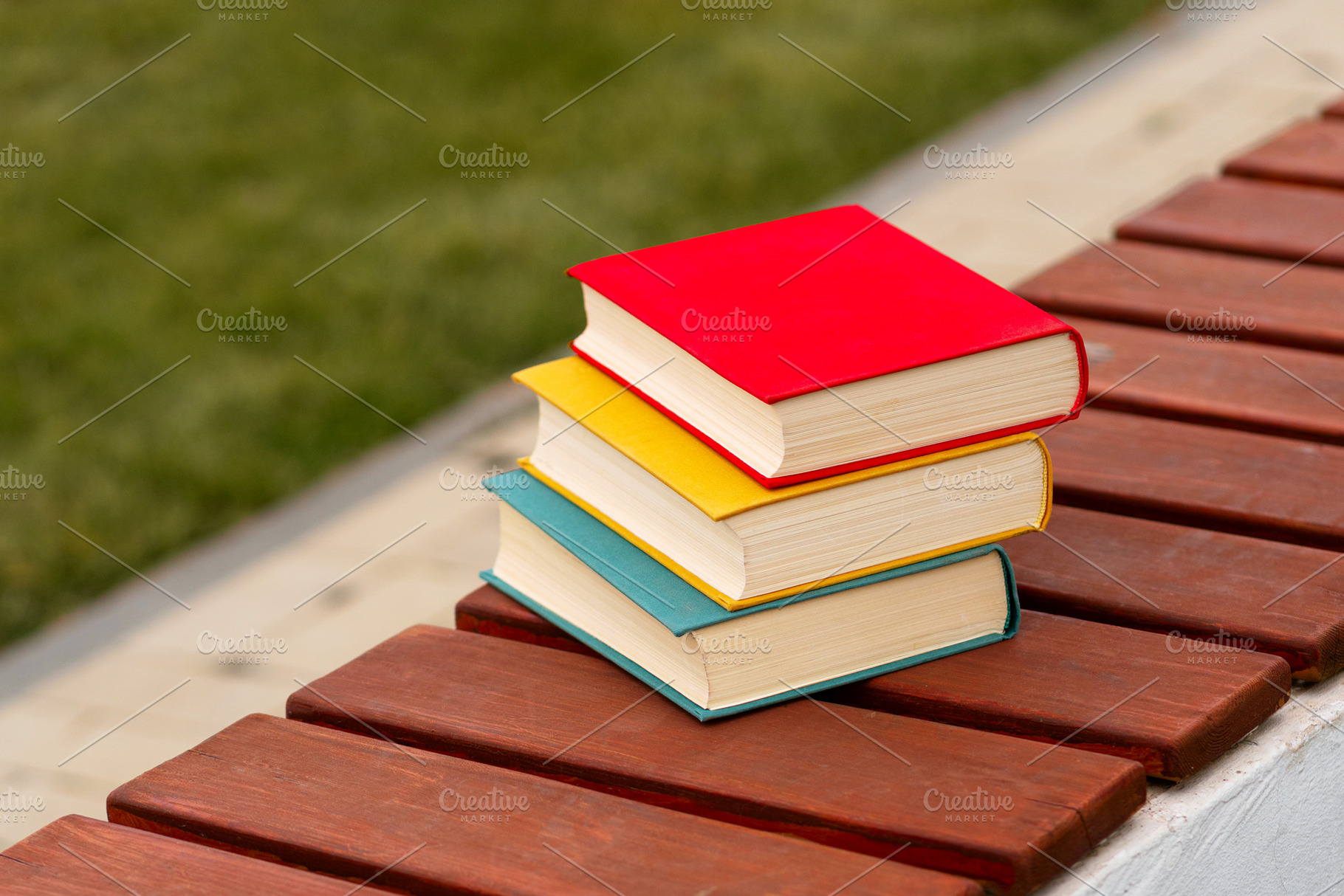 Three colorful books stacked, a School & Education Photo by Elena Vagengeim