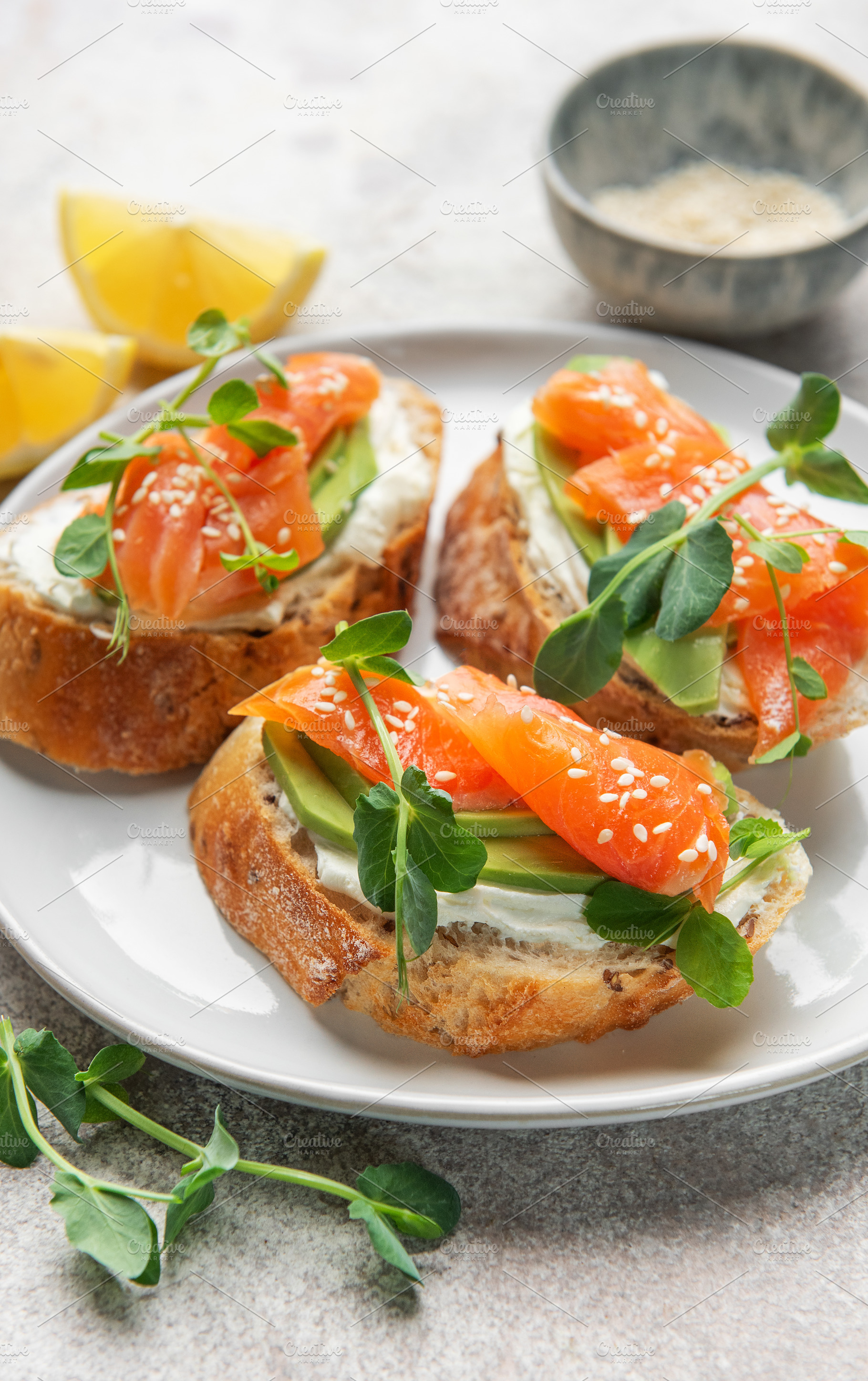 Smoked salmon toast with avocado, cream cheese, and microgreens, a Food & Drink Photo by Olena Rudo