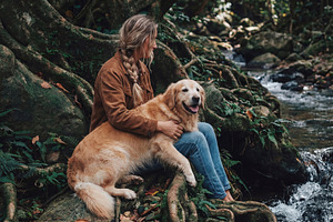 Woman and Golden Retriever sitting, a Nature Photo by Virgo Studio