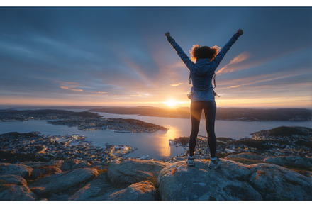 An adventurous man stands atop a, a Nature Photo by ZinetroN