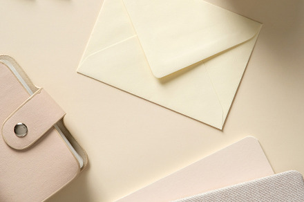 Stylish home office desk table with envelope, feminine accessories, paper noteb, a Holiday Photo by photoguns
