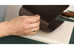 Hand sewing dark brown leather piece, a Person Photo by volodymyrshtun13795