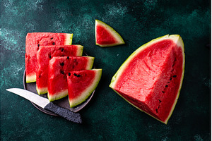 Sliced watermelon on green, a Food & Drink Photo by Yulia Furman