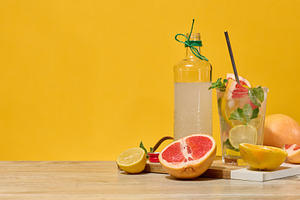Fresh citrus drink with lemon, grapefruit, and mint in a glass w, a Food & Drink Photo by ndanko