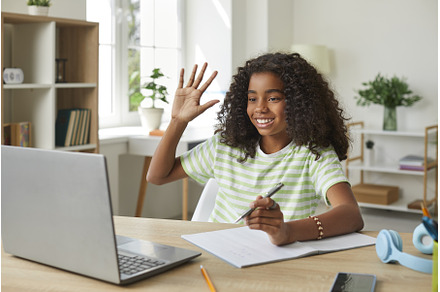 Girl greets classmates using remote, a School & Education Photo by StudioRomantic