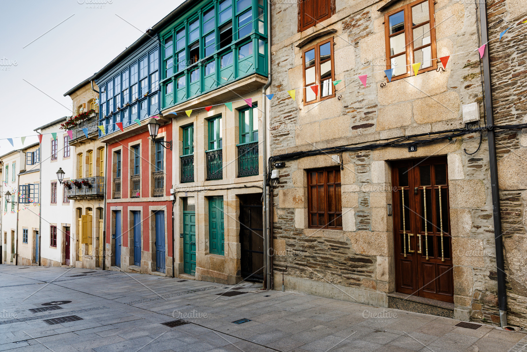 Colorful Historic Townhouses with Balconies and Bunting, Lugo, S, an Architecture Photo by Bepslabor