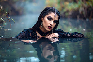 beautiful young goth woman in pond AI generated, a Photo by WorldOfPhotos