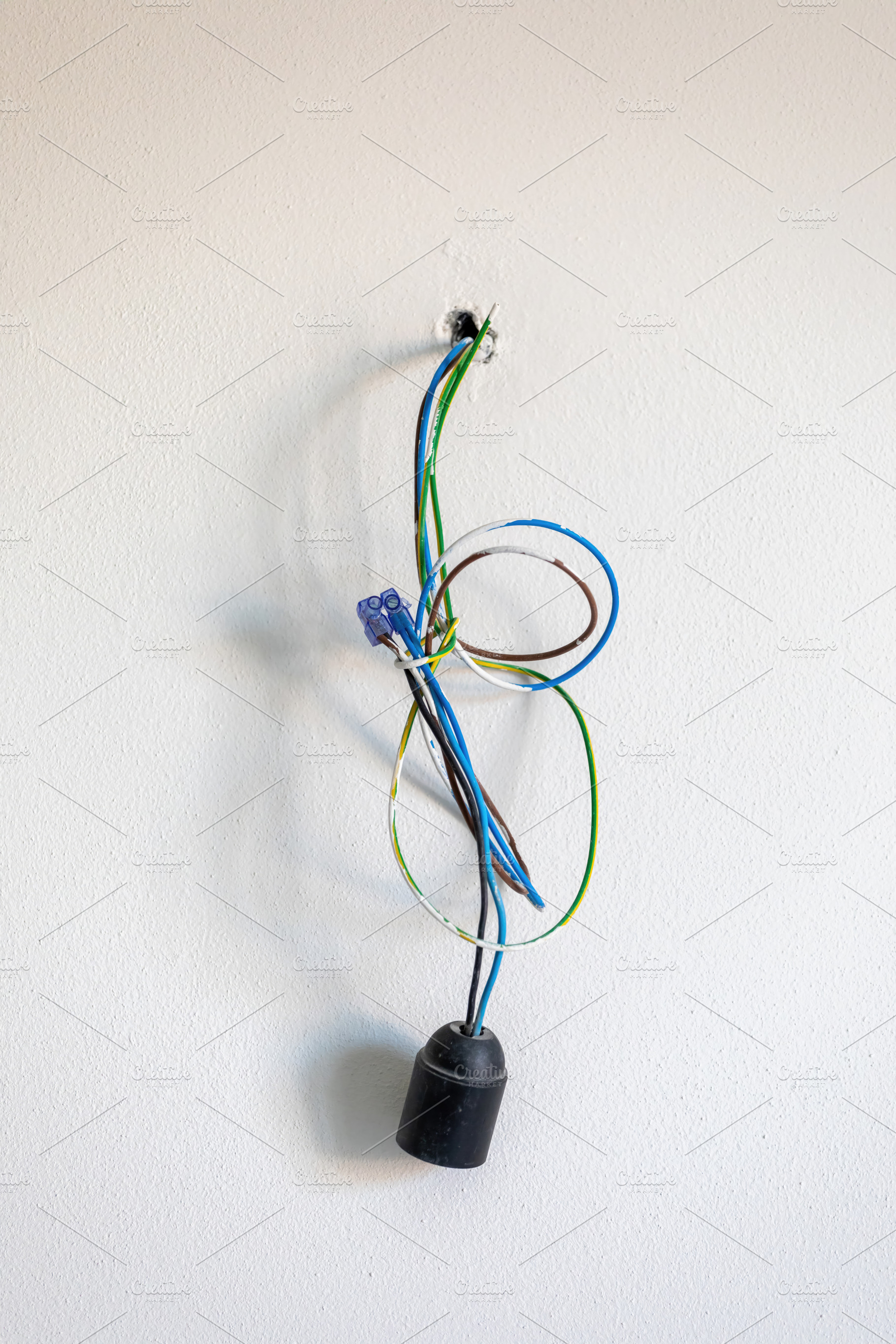 Electrical wires coming out of white wall with bulb holder, an Architecture Photo by Antonio Gravante Market