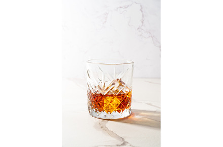 Whiskey with ice cube in the glass