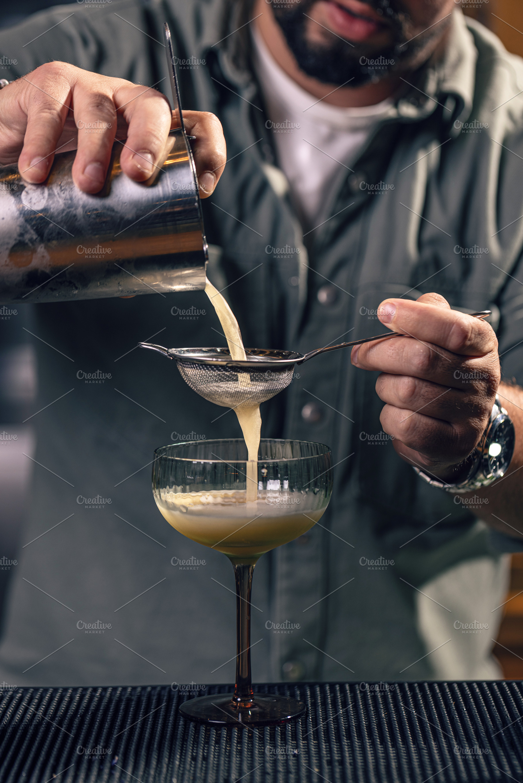 Professional bartender preparing a drink, a Photo by Grafvision photography