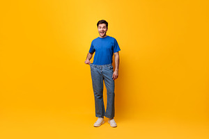Happy Man Pulling His Old Large Loose Jeans