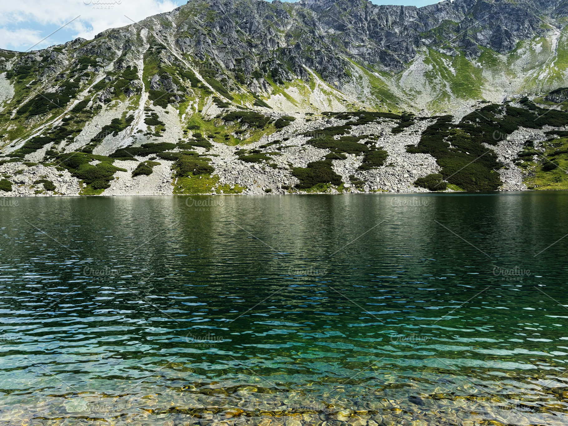 Tranquil mountain lake in Zakopane Poland with clear water and rocky alpine sho, a Nature Photo by AS photostudio