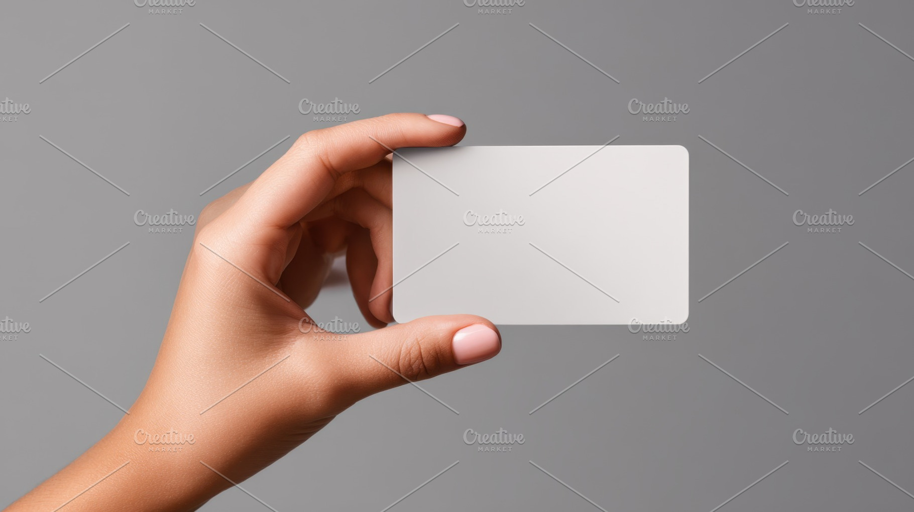 Hand with card on gray bg, a Photo by Beautiful things