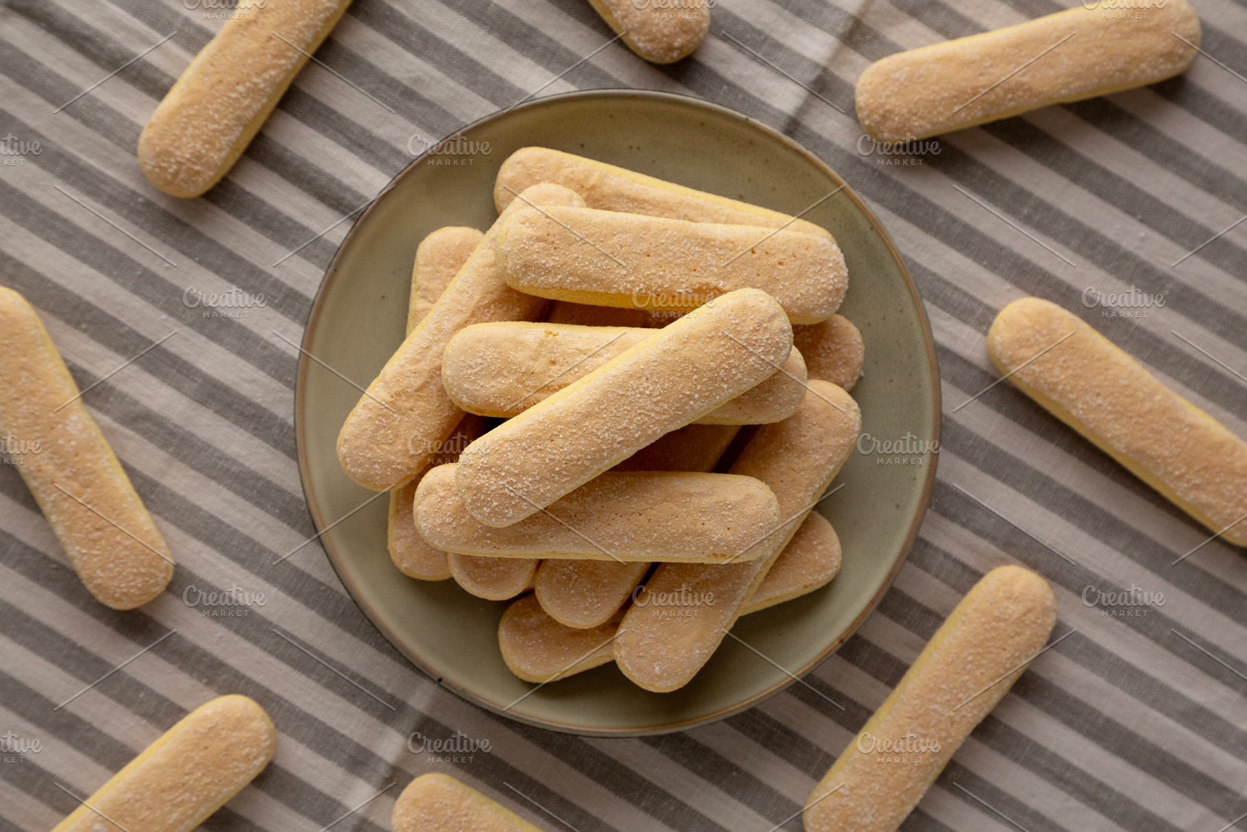 Savoiardi biscuits on a plate, top view., a Food & Drink Photo by LiudmylaChuhunova