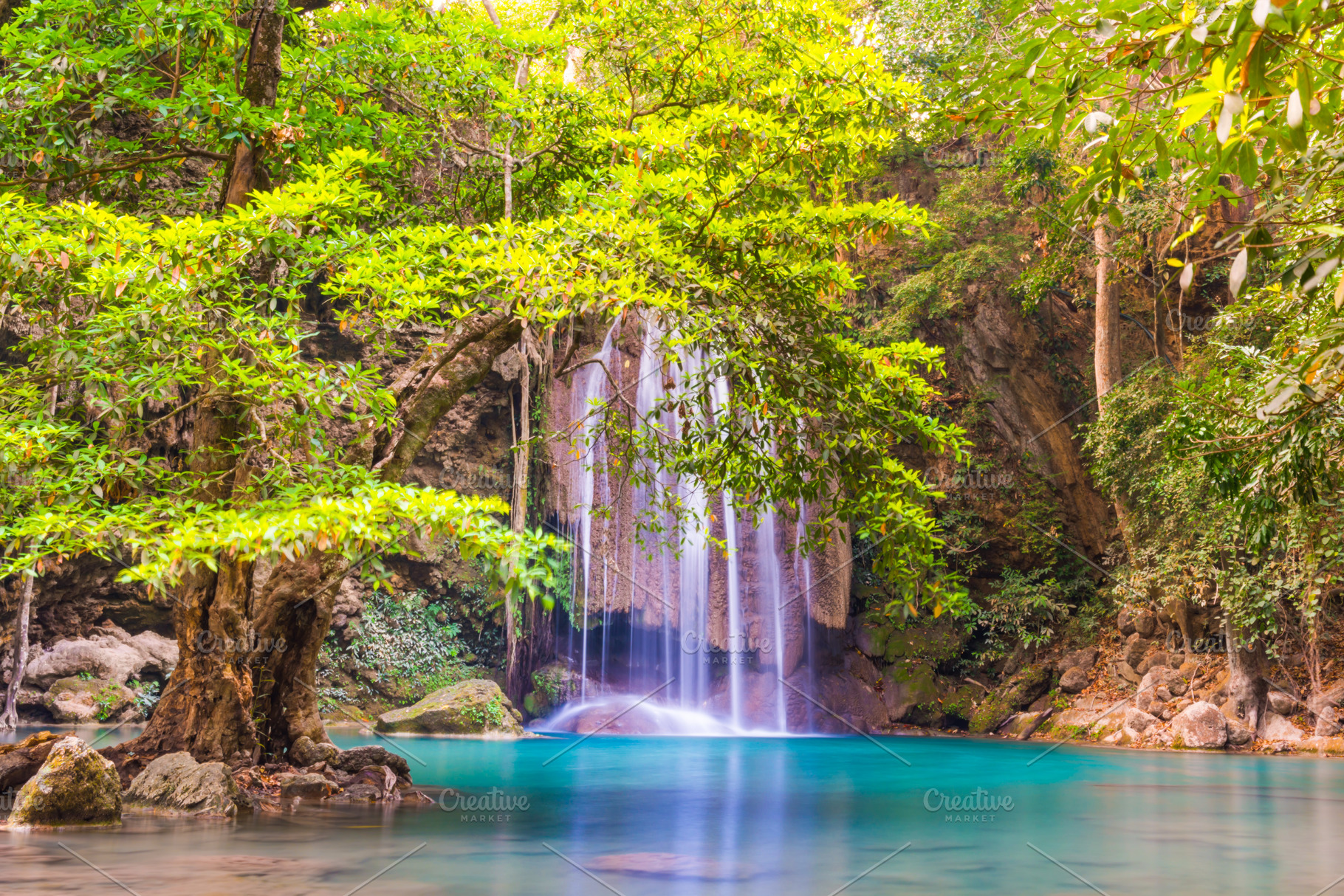 Waterfall in tropical forest with green tree and emerald lake, E, a Nature Photo by Vapi