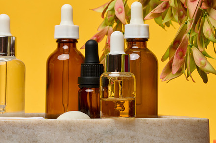 Cosmetic bottles-droppers brown, transparent with liquid on a ma
