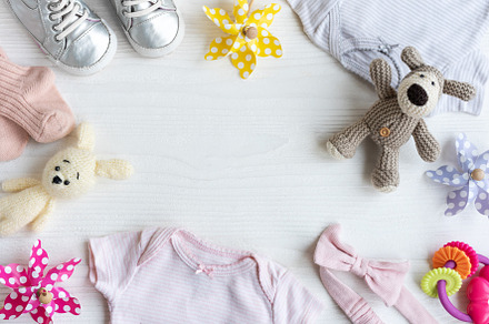 Baby clothes with knitted toys dog and rabbit, toy windmills and, a Beauty & Fashion Photo by Olena Rudo