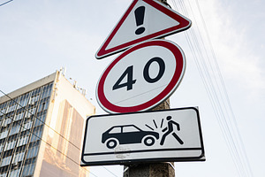 Urban road sign warning about speed limits and pedestrian safety in a city, a Photo by AS photostudio