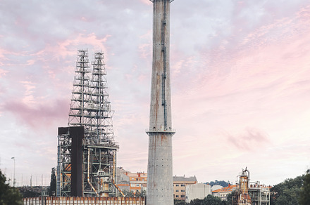 Refinery smokestack, urban backdrop, an Industrial Photo by SkyNext