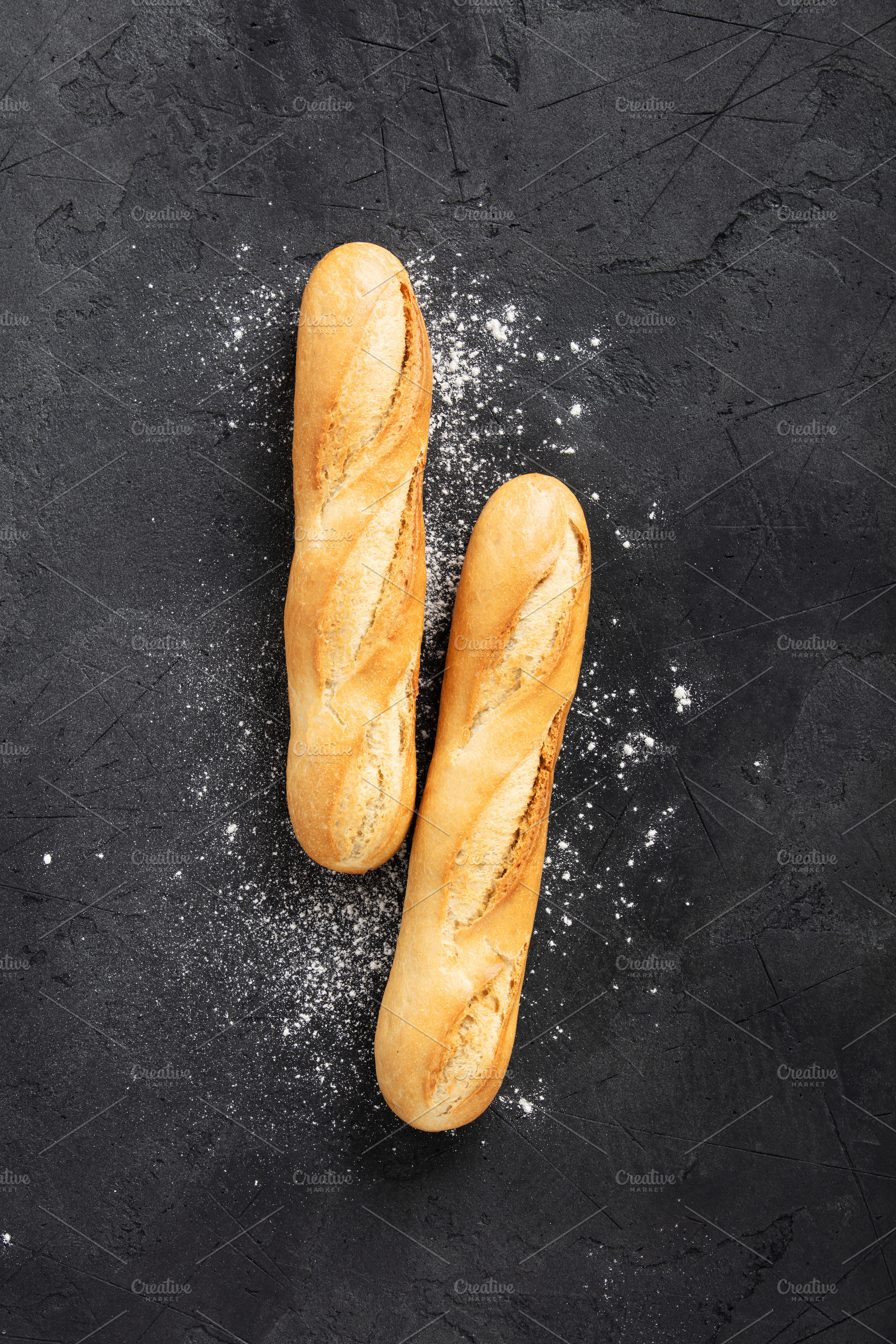 Two Fresh Baguettes with Flour on Dark Textured Surface, a Food & Drink Photo by Natalia Klenova's Shop