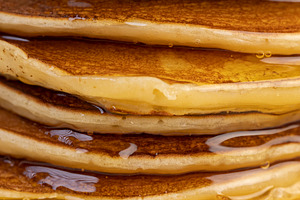 drizzled with honey, a large number of delicious pancakes stacked together on a, a Photo by rsoollAI