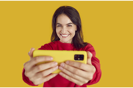 Cheerful woman is taking selfie shot, a Person Photo by StudioRomantic
