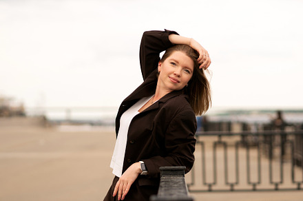Woman in brown suit resting arm