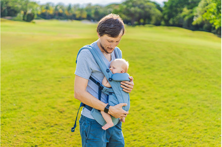 Young father walks in nature with