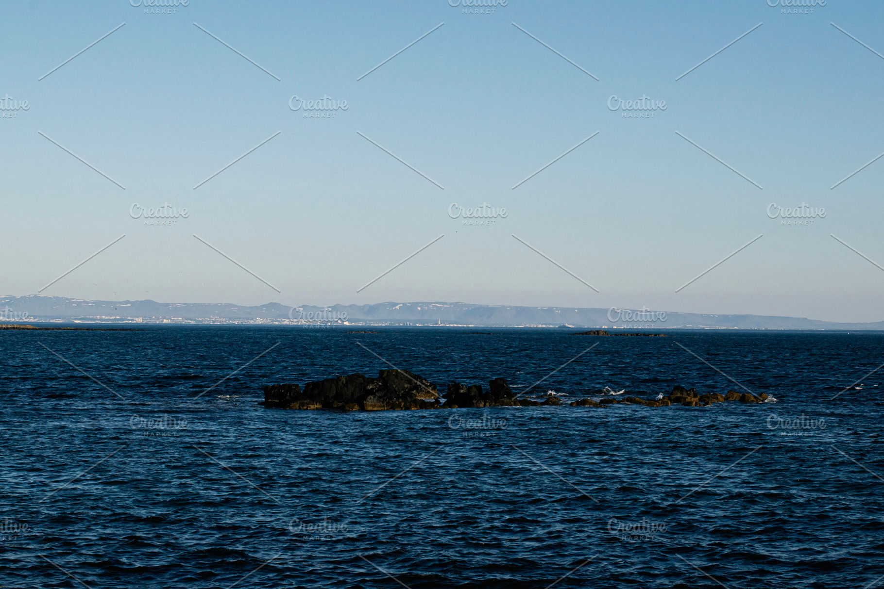 Scenic view of Akranes coastline and ocean with clear blue skies, a Photo by AS photostudio