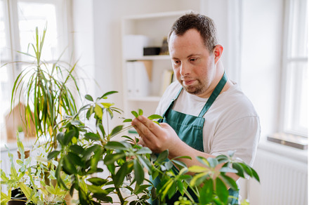 Young man with Down syndrome taking, a Person Photo by HalfPoint