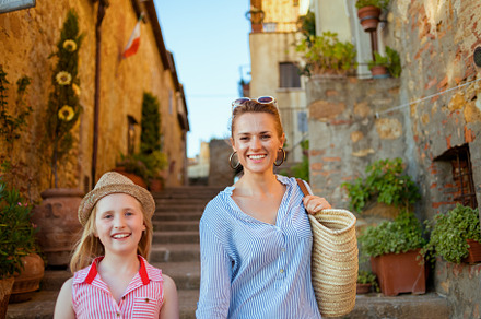 happy trendy mother and child travellers exploring attractions, a Person Photo by Alliance Images