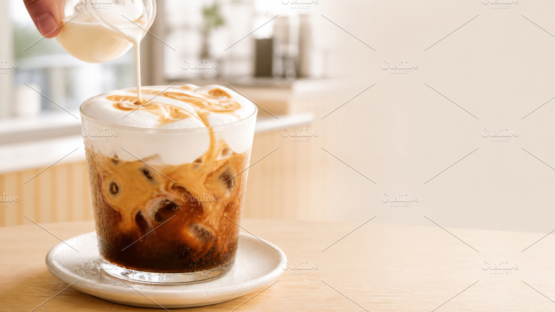 Creamy iced coffee being poured into, a Photo by Dvoevnore photos