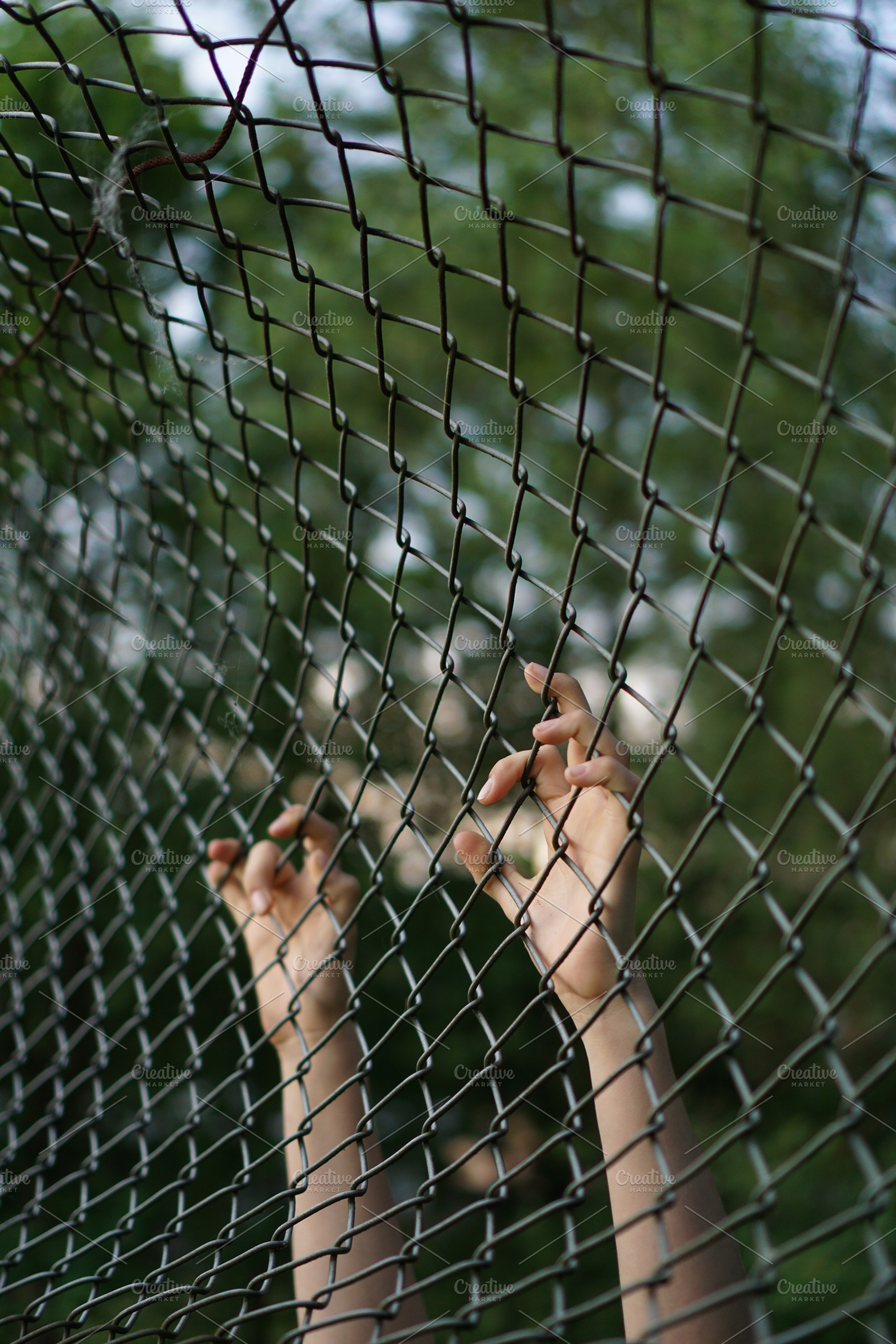 Trapped containing fence, child, and hands, a Person Photo by ateliervonau