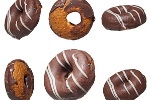 Six chocolate donuts decorated with white stripes of icing, isol, a Food & Drink Photo by ndanko