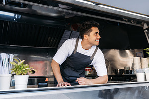 Confident chef in food truck, a Business Photo by Artem Varnitsin