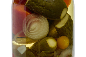 Glass jar with pickled whole cucumbers, red tomatoes, half an on, a Food & Drink Photo by ndanko