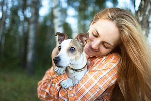 Young girl hugging her dog