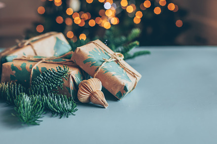 Gift boxes and paper ornate on wooden table. Christmas background with copy spa
