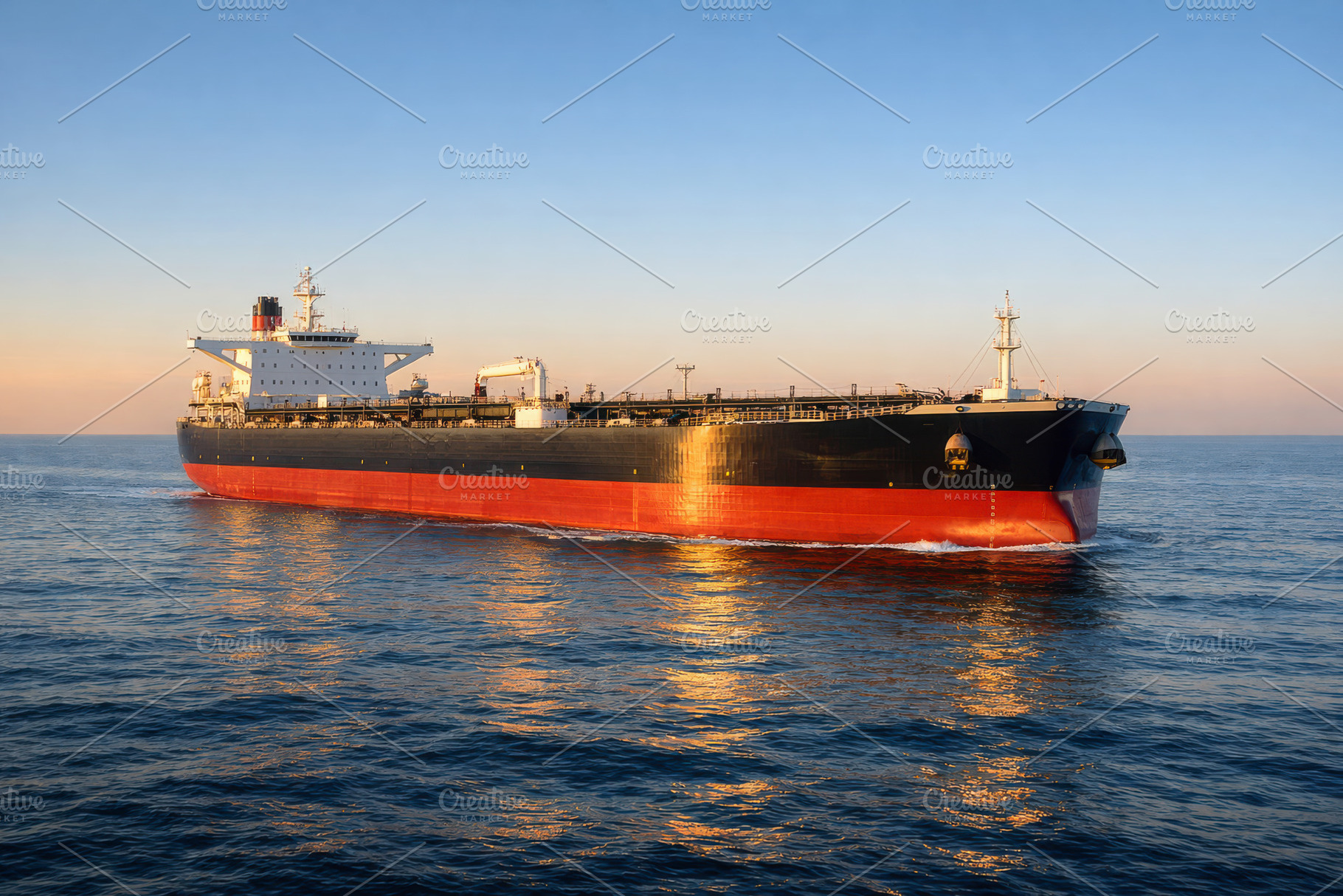 Oil Tanker at Sunset in Golden Light, an Industrial Photo by Perpis