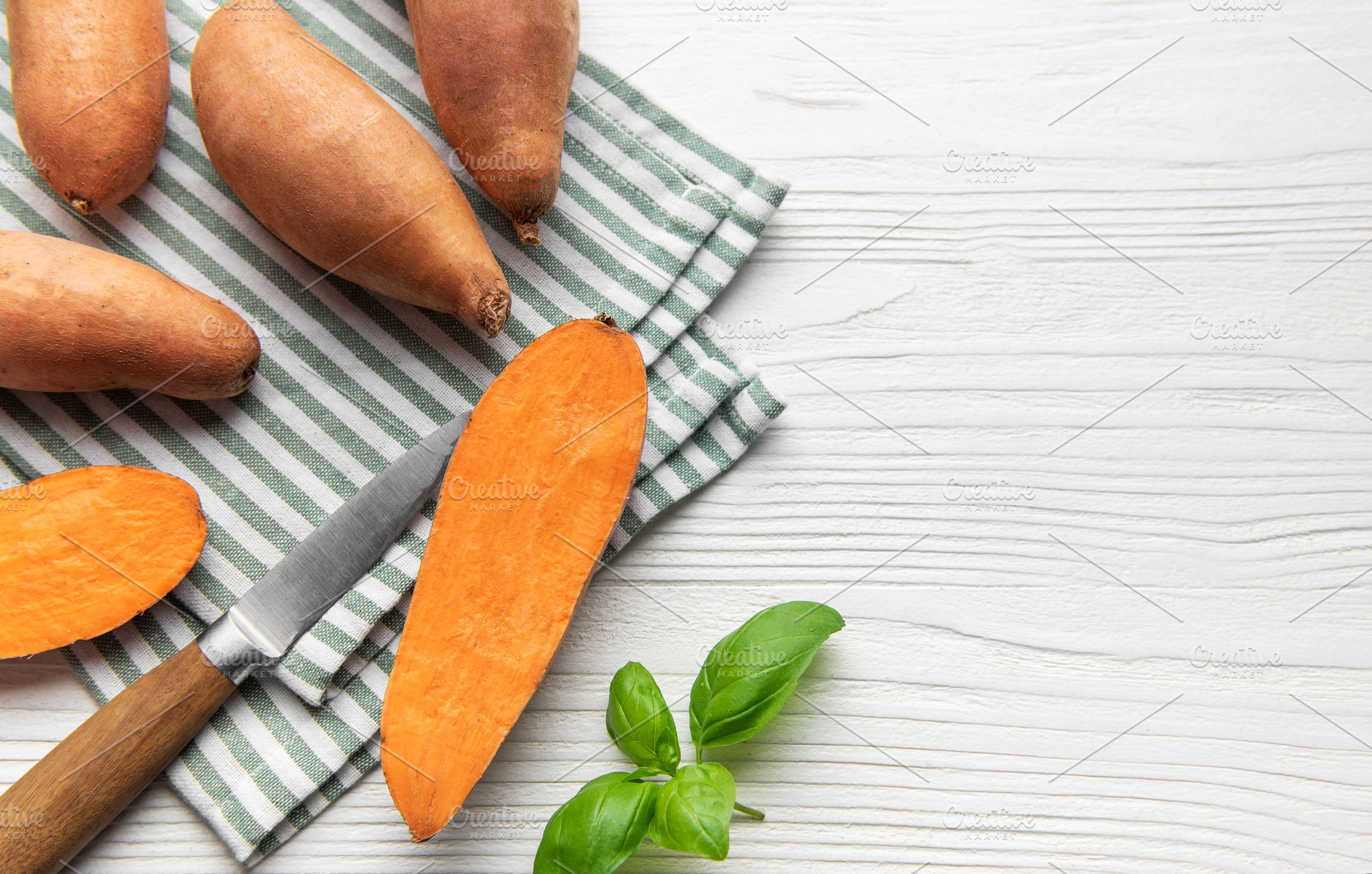 Sweet potato preparation with basil on striped napkin, a Food & Drink Photo by Olena Rudo