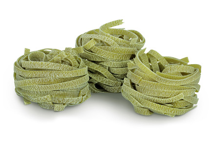 Raw tagliatelle green pasta with, a Food & Drink Photo by NataPhoto