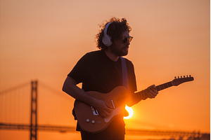 Street musician playing electric, a Person Photo by f9photos