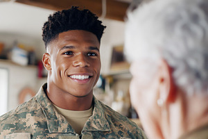 Young african american soldier smiling at elderly woman in cozy, a Photo by Dvoevnore photos